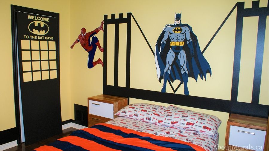 A batman wall mural, painted by Adrienne of AboutMurals.ca, features Batman and Spiderman on a bridge.