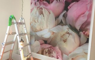 Peony Wallpaper, as seen on the wall of this room, features large pink and white flowers. Floral wallpaper sold by AboutMurals.ca.