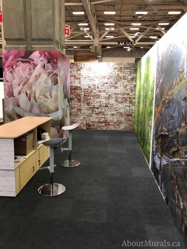 Peony Wallpaper, as seen on the wall of this tradeshow, features pastel pink flowers on removable wallpaper sold by AboutMurals.ca