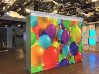 Balloon Wallpaper, as seen on this wall at Cityline, features a wall full of rainbow colored balloons from About Murals.