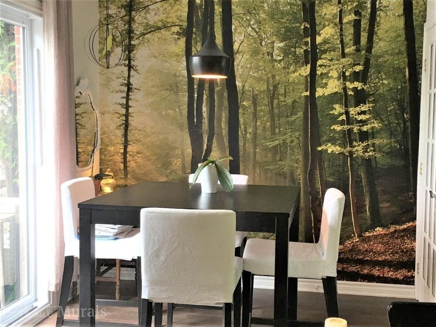 Sunbeams Wallpaper, as seen on the wall of this dining room, features sun streaming through trees in a forest. Forest wallpaper sold by AboutMurals.ca.