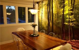 Sunbeams Wallpaper, as seen on the wall of this kitchen, features sun shining through trees in a forest. Forest wallpaper sold by AboutMurals.ca.