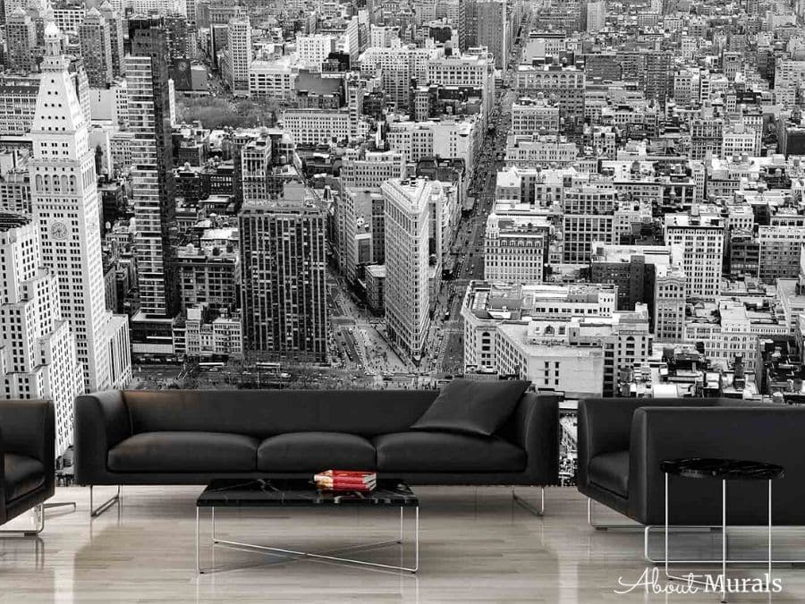 Birds Eye View of Manhattan Wallpaper, as seen on the wall of this modern living room, features a New York skyline full of skyscrapers. New York wallpaper sold by AboutMurals.ca.