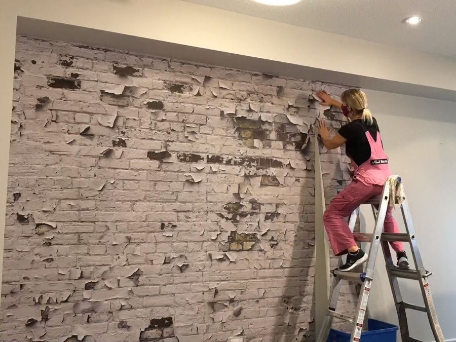 Adrienne of About Murals installs wallpaper.
