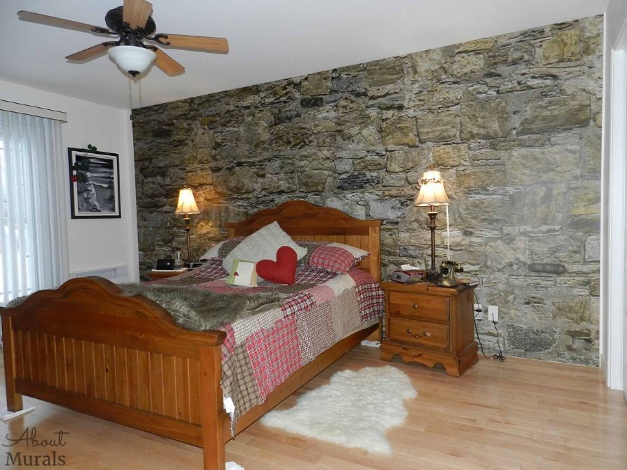 Castle Stone Wallpaper, as seen in this bedroom, features a wall of rugged brown rocks. Easy wallpaper sold by AboutMurals.ca.