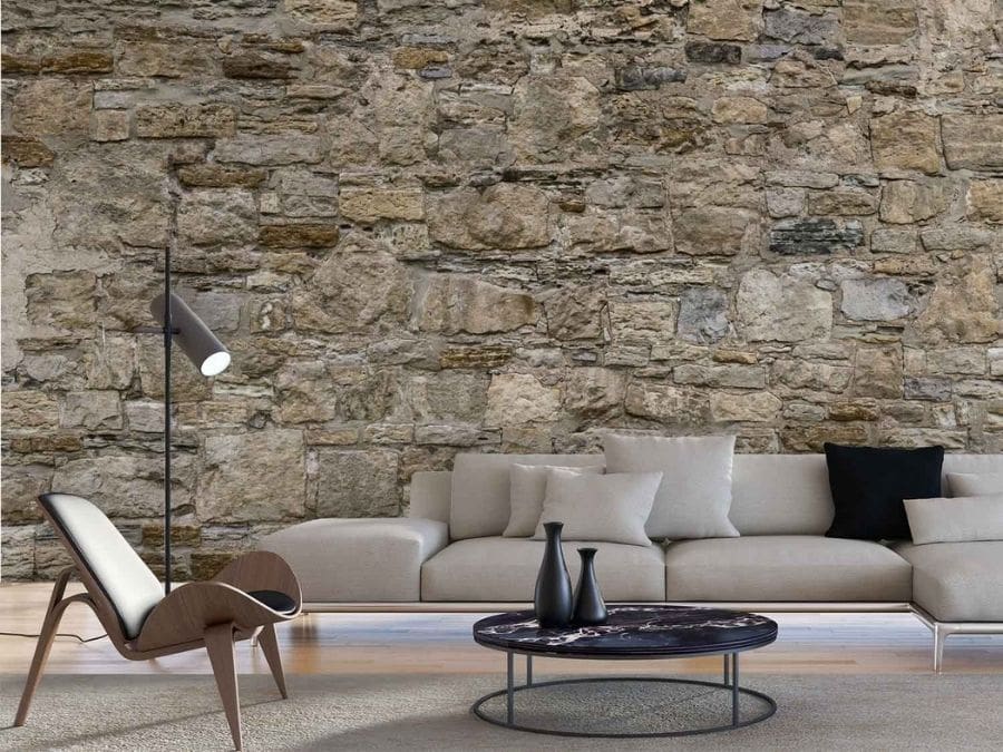 Castle Stone Wallpaper, as seen on the wall of this brown living room, is a photo mural of realistic looking beige stones from About Murals.