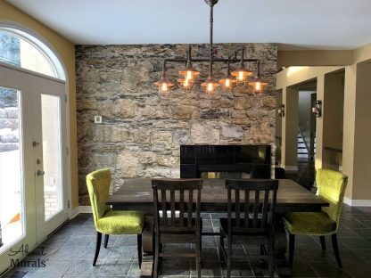 Castle Stone Wallpaper, as seen in this dining room, features a wall of rugged brown rocks. Easy wallpaper sold by AboutMurals.ca.