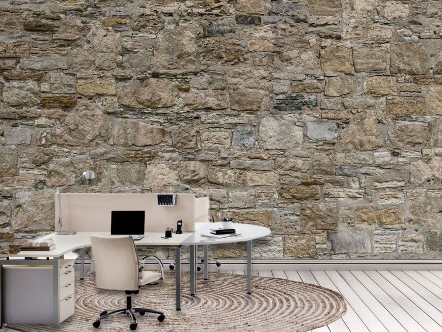 Castle Stone Wallpaper, as seen on the wall of this office, is a high resolution photo mural of brown stacked stones full of texture from About Murals.