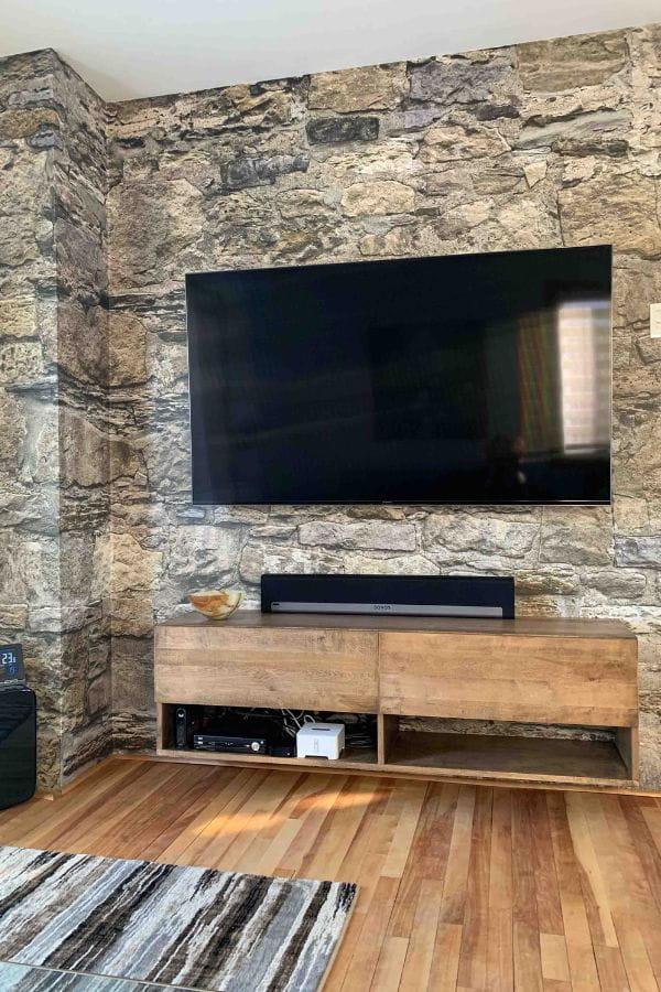 Castle Stone Wallpaper, as seen on the wall of this TV Room, is a high resolution photo mural of brown stones full of texture from About Murals.