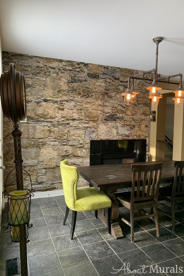 Faux Stone Wallpaper, as seen in this dining room, features a wall of rugged brown rocks. Buy easy wallpaper on AboutMurals.ca.
