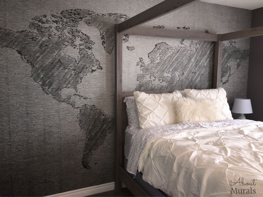 Textured Gray World Map Wallpaper, as seen on the wall of this bedroom, features a simple, neutral watercolor design. Easy wallpaper sold by AboutMurals.ca.