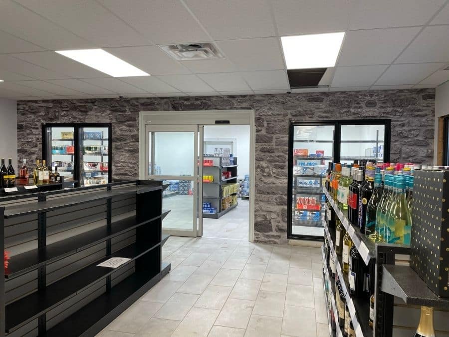 Grey Stone Wallpaper, as seen on the wall at Freeflow Petroleum Convenience Store, is a stone effect wallpaper with realistic texture from About Murals.