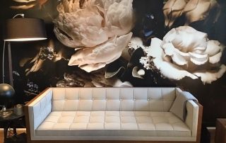 Black Floral Wallpaper, as seen on this living room wall, feels beautiful with peony and rose flowers on a dark background. Flower wallpaper sold by AboutMurals.ca.