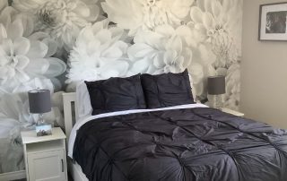 Black and White Flower Wallpaper, as seen on the wall of this dark bedroom, is a photo mural of beautiful oversized dahlias from About Murals.