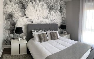 Black and White Flower Wallpaper, as seen on the wall of this grey bedroom, is a photo mural of oversized gray dahlias from About Murals.