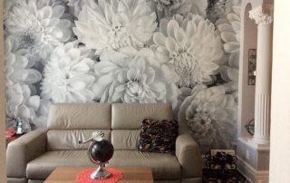 Black and White Flower Wallpaper, as seen on the wall of this living room, creates a beautiful accent wall with its gray dahlia flowers. Floral wallpaper from AboutMurals.ca.
