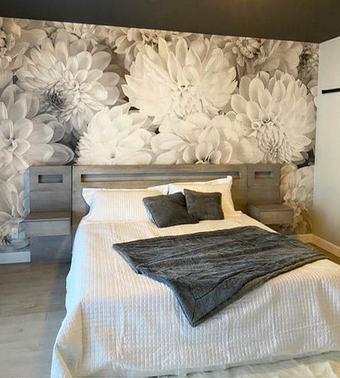 Black and White Flower Wallpaper, as seen on the wall of this monochrome bedroom, is a photo mural of large black and white dahlias from About Murals.