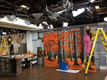 Red Forest Wallpaper being installed by Adrienne of About Murals on set at Cityline in Toronto, ON