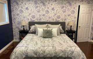 Blue Toile Wallpaper, as seen on the wall of this bedroom, is a floral mural with hydrangea, tulip, peony, lily and carnation flowers with butterflies from About Murals.
