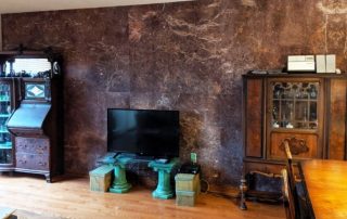 Dark Brown Marble Wallpaper, as seen on the wall of this traditional living room, creates a rich feeling with its large marble tiles. Marble wallpaper sold by AboutMurals.ca.