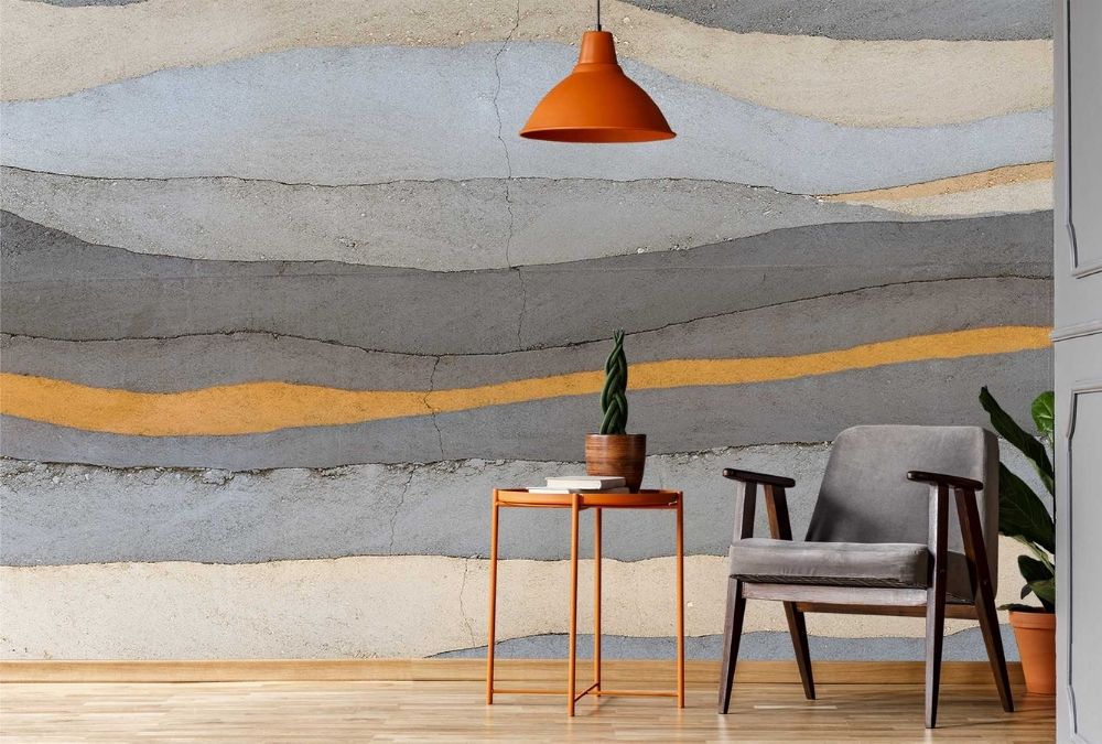 Grey and Yellow Concrete Wallpaper, as seen on the wall of this living room, features layers of cracked concrete from About Murals.