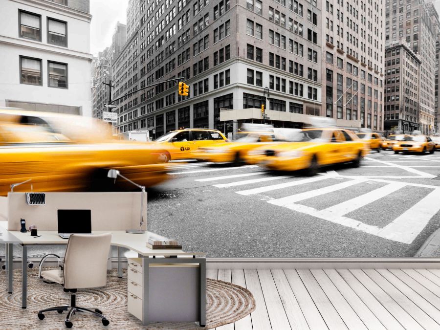 New York Yellow Taxi Wallpaper, as seen on the wall of this office, is a photo mural of yellow cabs speeding down a black and white street in NYC from About Murals.