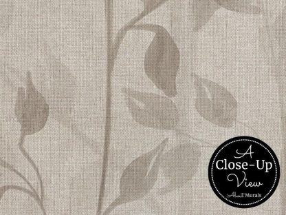 A close-up view of leaves on a burlap background in a beige leaf wallpaper from About Murals.