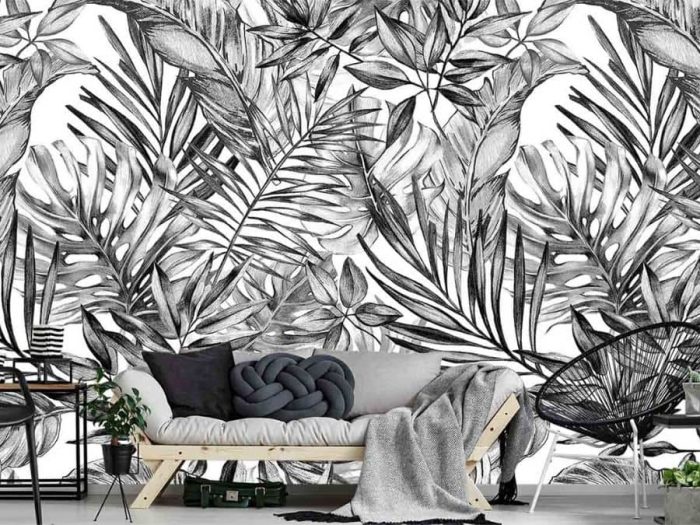 Black and White Tropical Wallpaper, as seen on the wall of this living room, features palm leaves, banana leaves and monstera leaves on a white background from About Murals.