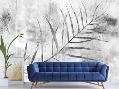 Grey Palm Leaf Wallpaper, as seen on the wall of this living room, features a single palm leaf on a concrete textured background from About Murals.