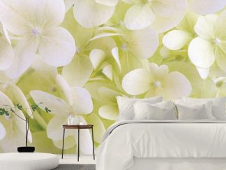 White Hydrangea Wallpaper, as seen on the wall of this bedroom, features a close-up of beautiful flower petals from About Murals.