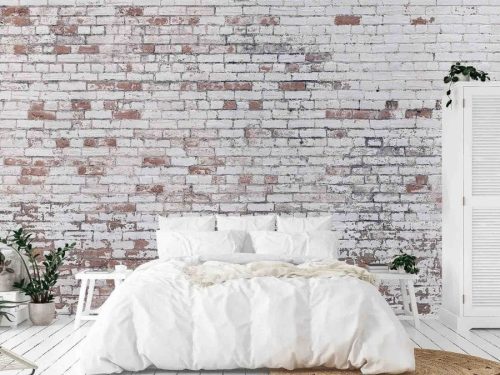 Distressed Brick Wallpaper, as seen on the wall of this bedroom, features white decaying paint over red brick from About Murals.