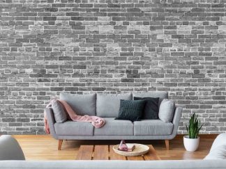 Black and White Brick Wallpaper, as seen on the wall of this living room, features realistic, textured looking grey bricks from About Murals.