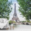 Eiffel Tower Wallpaper, as seen on the wall of this living room, features the famous lattice tower overlooking the Pont D'Iena and La Seine in Paris, France from About Murals.