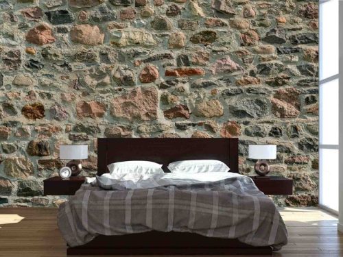 Field Stone Wallpaper, as seen on the wall of this bedroom, is a photo mural of a beige, brown and orange stone wall from About Murals.