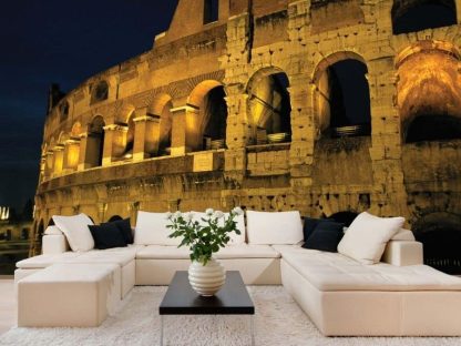 Rome Wallpaper, as seen on the wall of this living room, is a photo mural of the Roman Colosseum lit up against a dark night sky from About Murals.