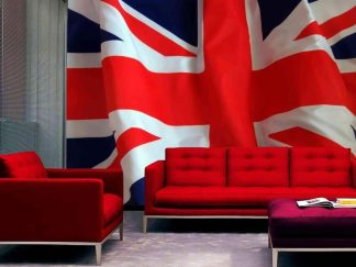 British Flag Wallpaper, as seen on the wall of this living room, features the union jack proudly billowing in the wind from About Murals.