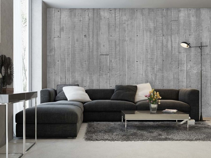 Concrete Look Wallpaper, as seen on the wall of this black living room, is a photo wallpaper of grey concrete planks from About Murals.