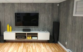 Concrete Look Wallpaper, as seen on the wall of this TV Room, is a photo wall mural of vertical concrete slabs from About Murals.