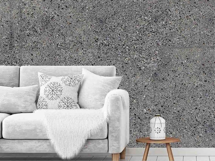Concrete Stone Wallpaper, as seen on the wall of this living room, is a photo mural of exposed aggregate from About Murals.