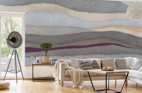 Grey and Purple Concrete Wallpaper, as seen on the wall of this living room, features layers of realistic concrete in gray, purple, yellow and light blue from About Murals.