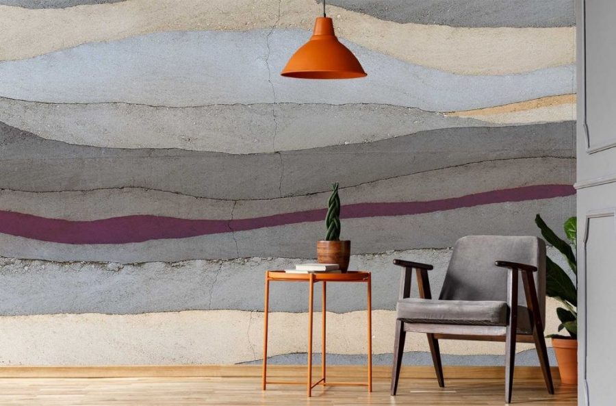 Grey and Purple Concrete Wallpaper, as seen on the wall of this sitting room, features a horizontal painted stripe on a grey concrete wall from About Murals.