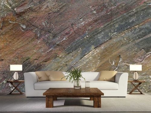 Rock Effect Wallpaper, as seen on the wall of this living room, is a photo mural of a brown and copper rock face wall from About Murals.