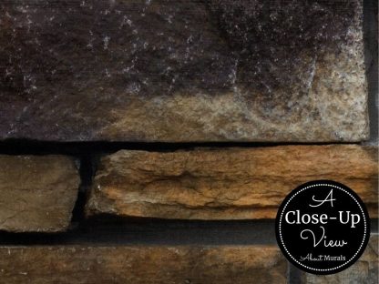 A close-up of brown slate stones in a stacked stone wallpaper from About Murals.