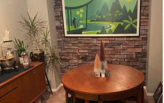 Stacked Stone Wallpaper, as seen on the wall of this mid century dining room, is a photo mural of realistic stones from About Murals.