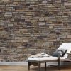 Stacked Stone Wallpaper, as seen on the wall of this spa, is a photo mural of a modern brown stone wall from About Murals.