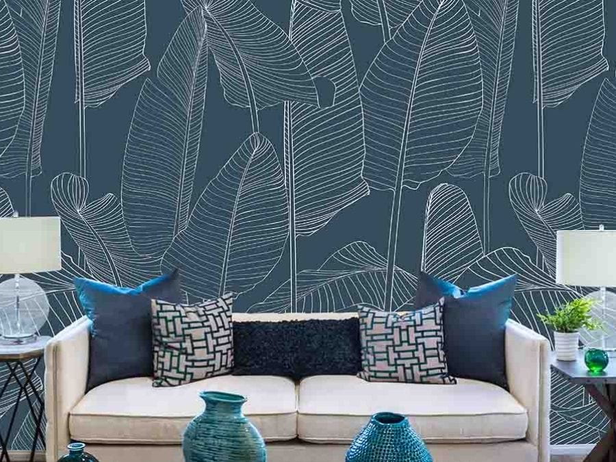 Blue Leaf Wallpaper, as seen on the wall of this living room, is a tropical mural with big banana leaves from About Murals.