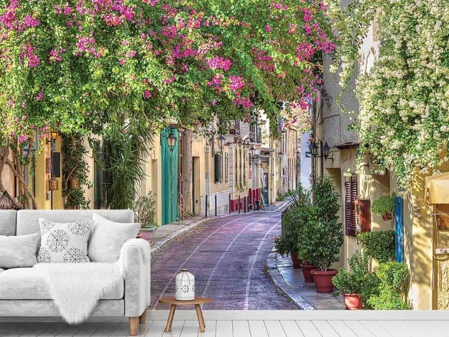 Bougainvillea Wallpaper, as seen on the wall of this living room, is a photo mural of a street in the Plaka neighbourhood of Athens, Greece from About Murals.