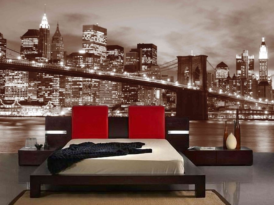 Brooklyn Bridge Park Wallpaper, as seen on the wall of this bedroom, is a brown photo mural of the New York City suspension bridge at night against skyscrapers and the East River from About Murals.