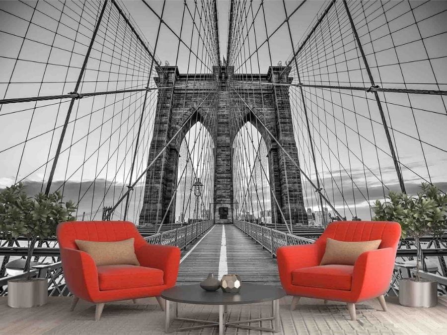 Brooklyn Bridge Wallpaper, as seen on the wall of this living room, is a black and white photo mural of the pedestrian walkway and the cables and wires suspending the iconic bridge from About Murals.
