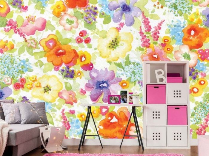 Colorful Flower Wallpaper, as seen on the wall of this kids room, is a mural with orange, pink, yellow, purple, green and red watercolor flowers from About Murals.